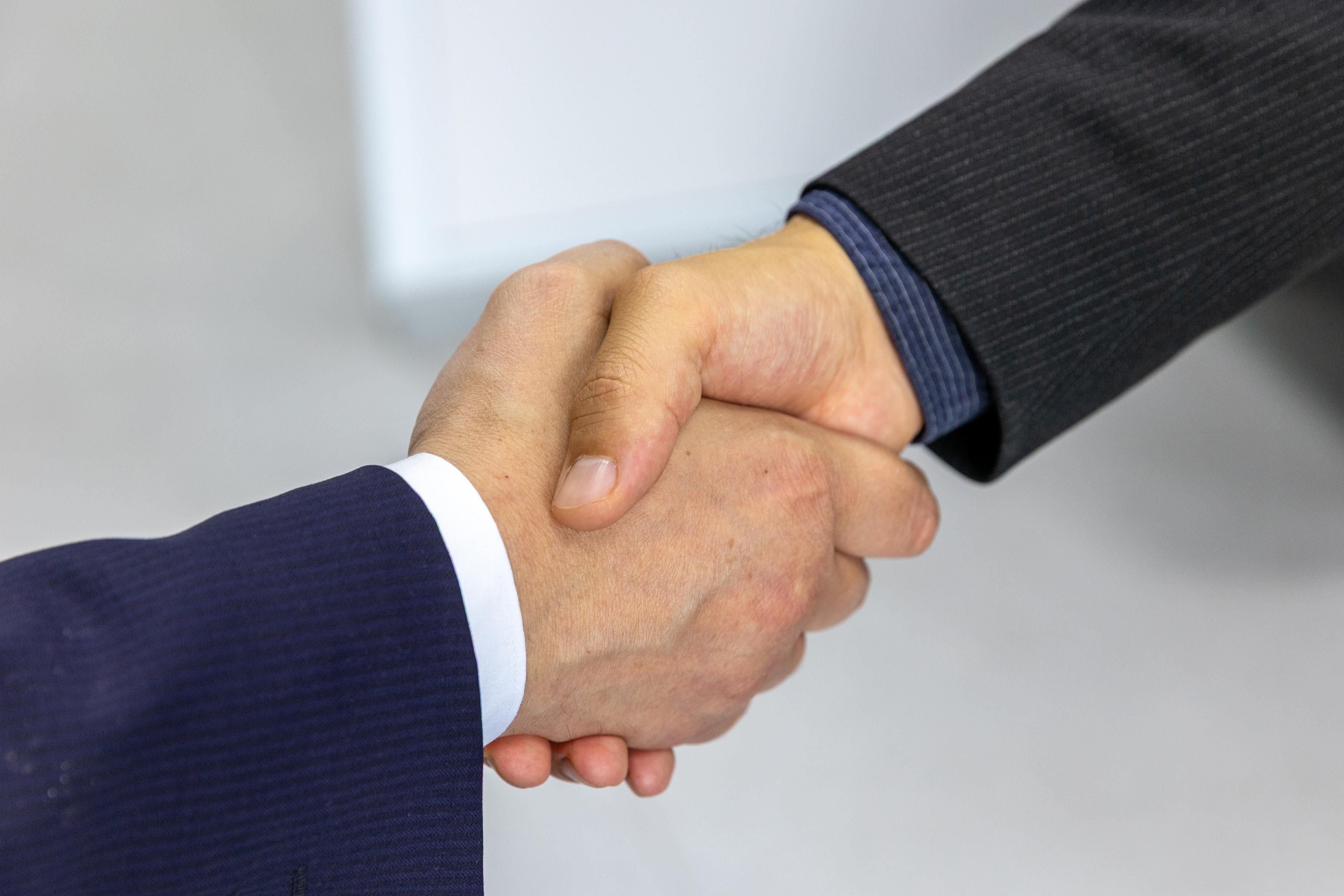 Business handshake symbolizing a litigation funding agreement between parties
