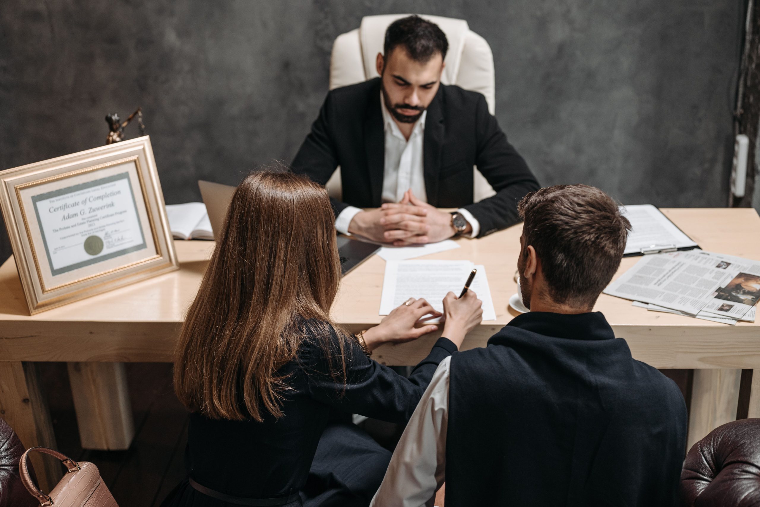 Lawyer explaining a litigation funding agreement to clients in an office