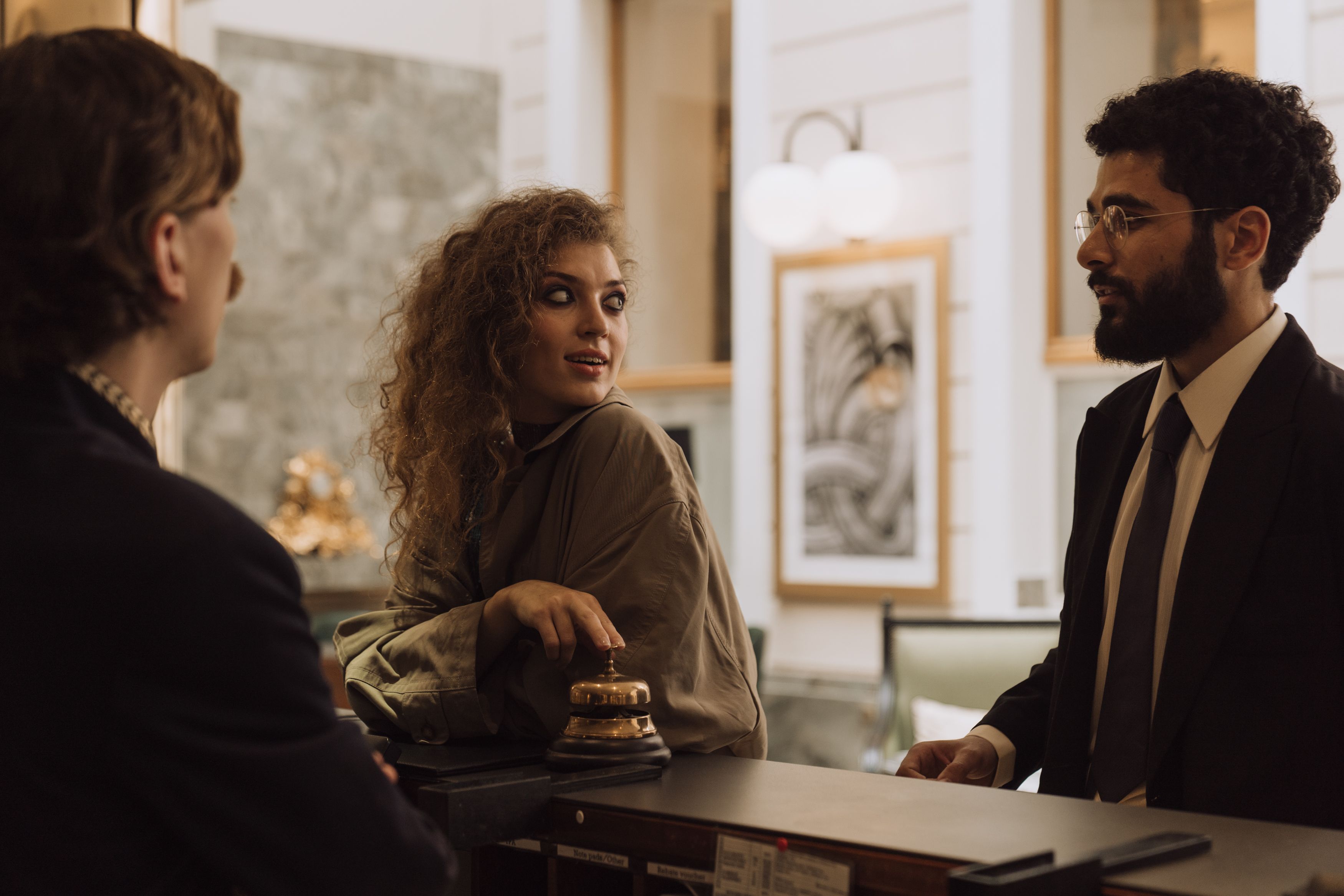 Hotel guests speaking with reception staff, reflecting the warm, attentive welcome that makes luxury hospitality memorable.
